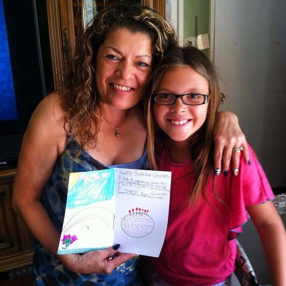 Gemma holding a handmade birthday card made by a child